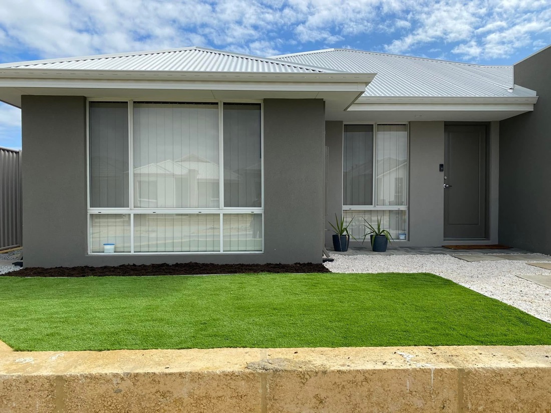 Same new-build frontage finished with a neat lush green lawn.